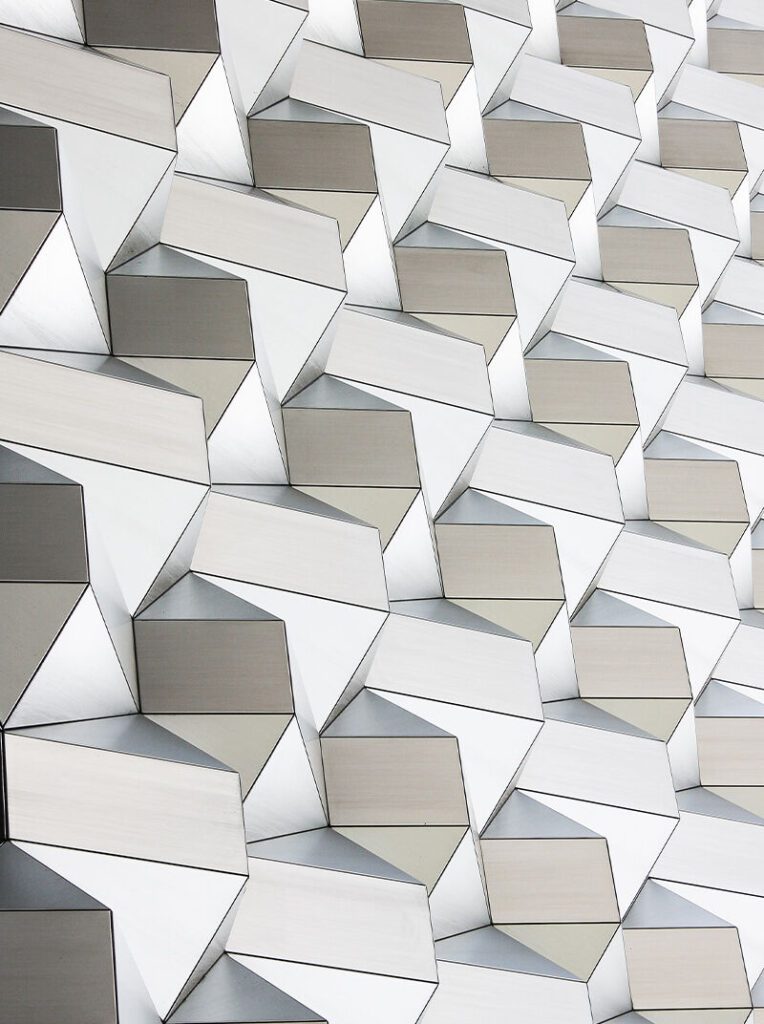 A wall of white and gray cubes with a geometric pattern.