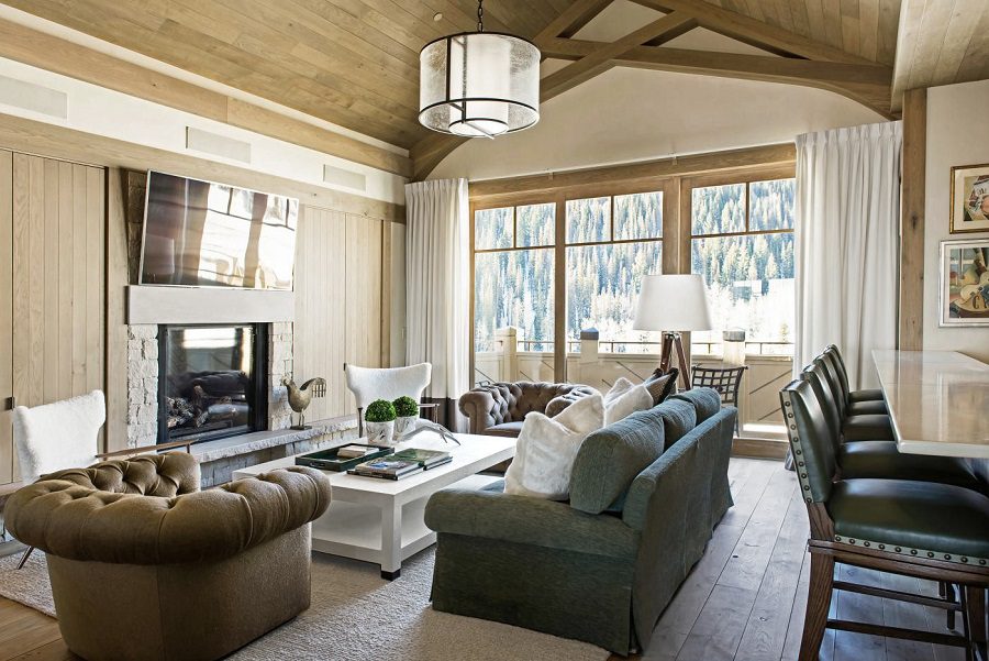 A living room with a fireplace and large windows.