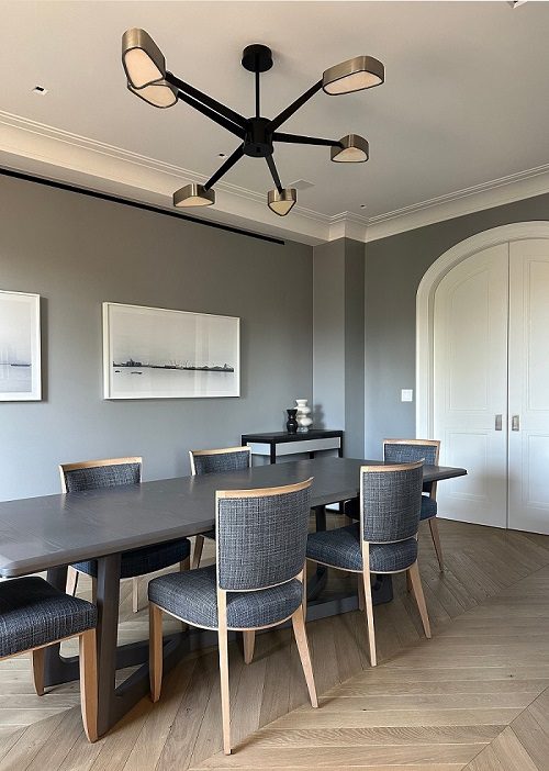 A dining room with a gray table and chairs.