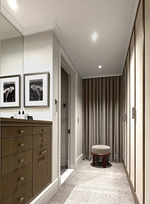 An image of a hallway with a mirror and a dresser.