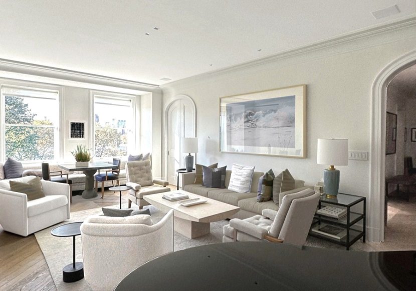 A living room with white furniture and a piano.