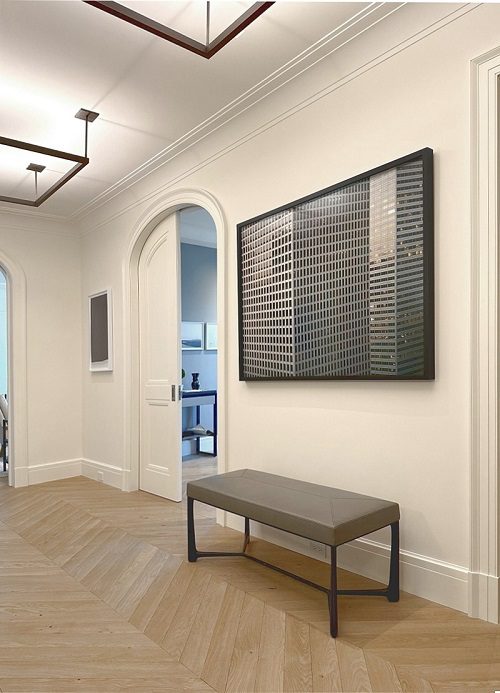 An image of a hallway with white walls and a bench.