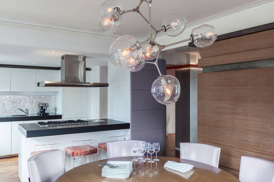 A modern kitchen with a dining table and chairs.