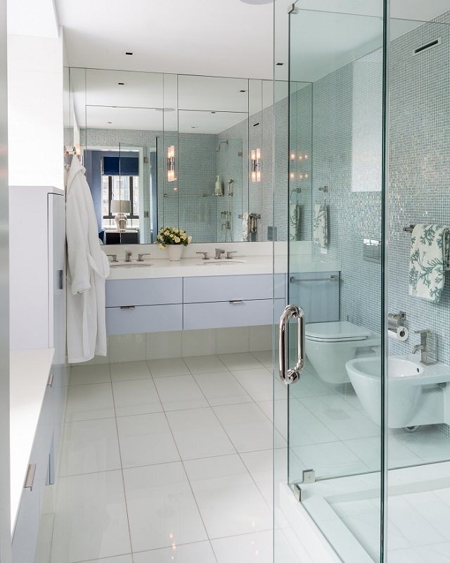 A bathroom with a glass shower and sink.