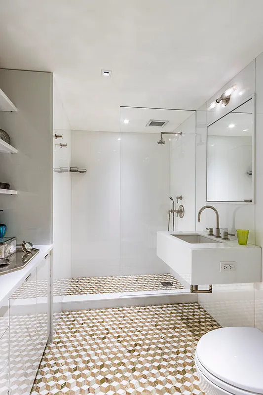 A bathroom with a sink and shower.