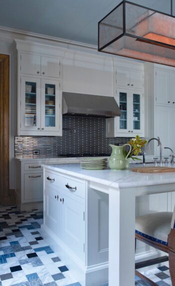 Kitchen renovation at The Dakota Apartments featuring Carlo Scarpa–inspired marble flooring and custom white cabinetry
