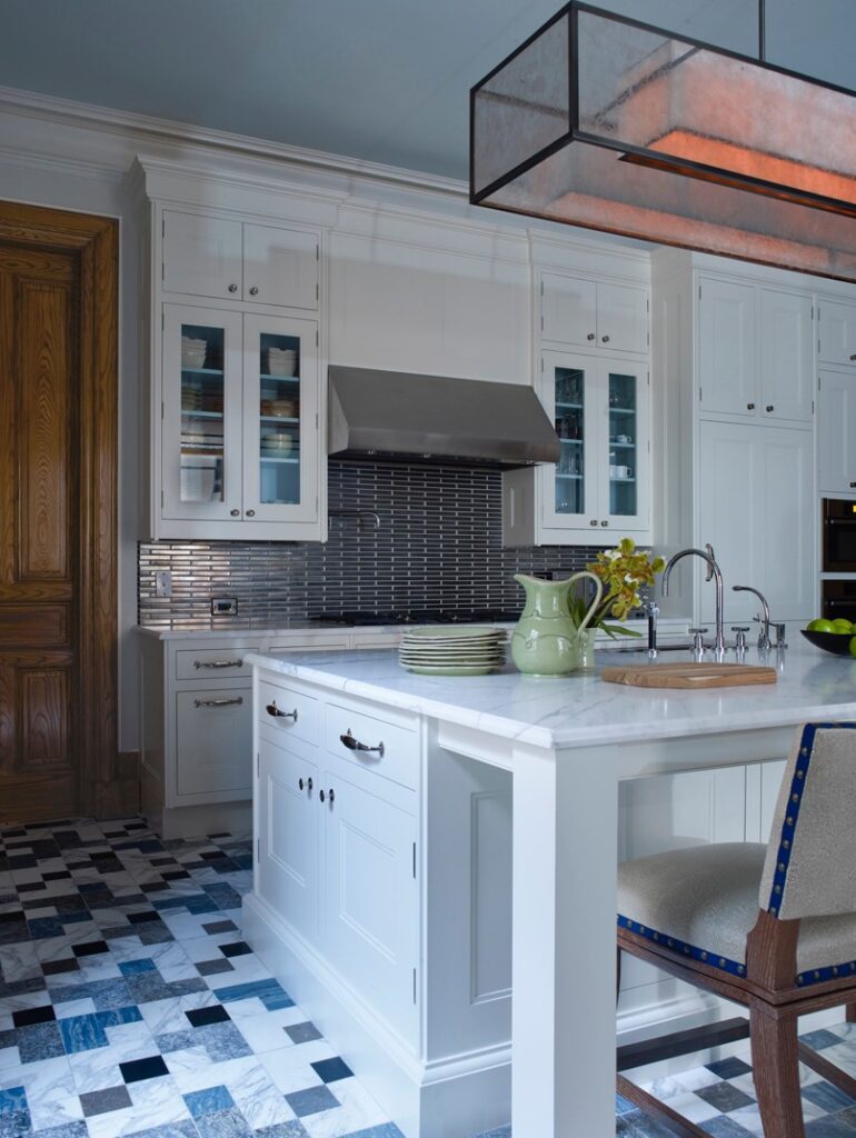 A kitchen with a blue and white checkered floor in a renovation in the Dakota apartments ny Mark Holmquist, Architect