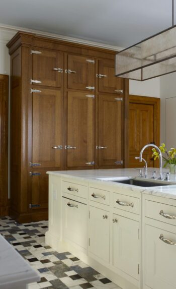 Landmark apartment kitchen renovation featuring Gothic-inspired millwork and contrasting white cabinetry