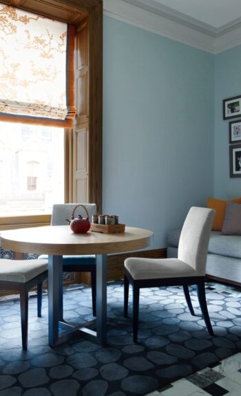 Breakfast area within The Dakota Apartments featuring restored wood paneling and Carlo Scarpa–inspired marble flooring