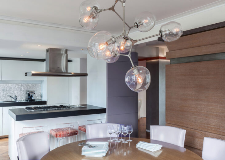 Manhattan Co-op apartment converted to Loft Loft-inspired Manhattan apartment dining area with cerused oak millwork and sculptural glass chandelier