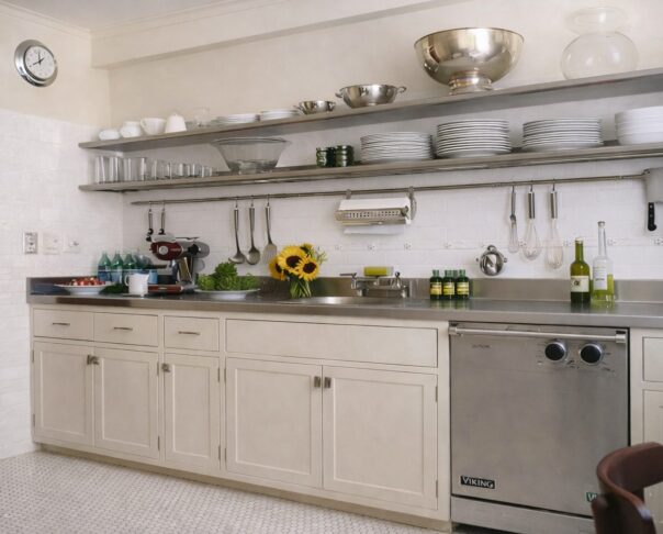Art Deco–inspired kitchen renovation at The Majestic featuring streamlined cabinetry and stainless-steel shelving